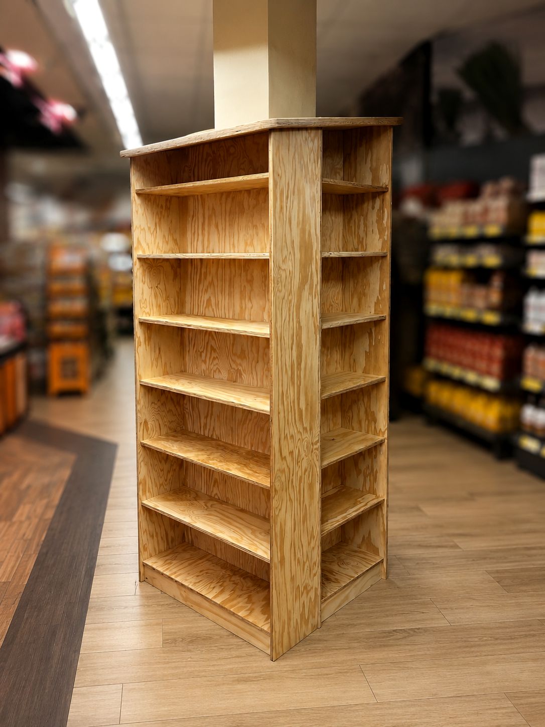Plywood shelving wrapped around a column in a supermarket