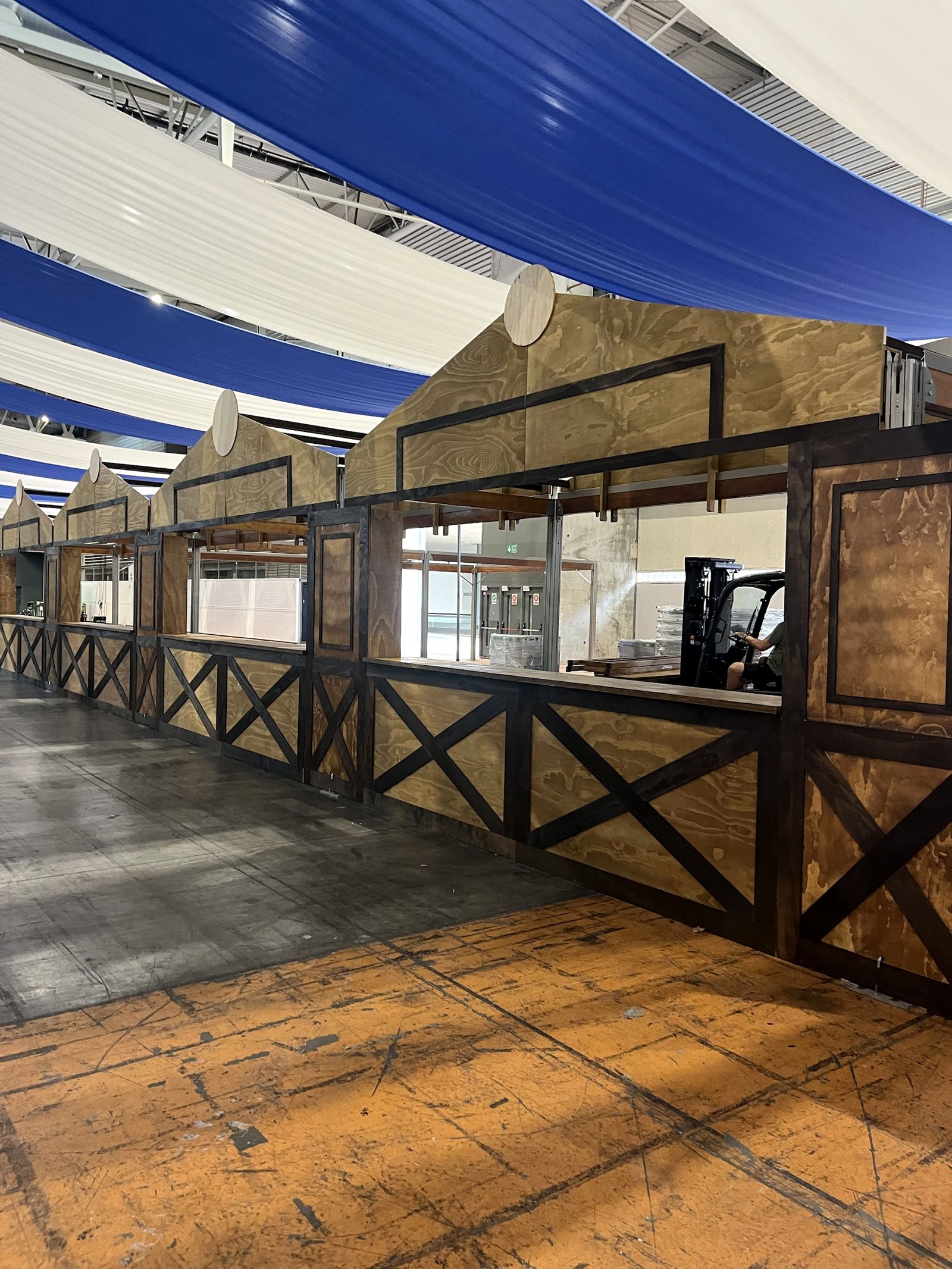 Plywood bar façade with dark cross-bracing for Oktoberfest Barcelona