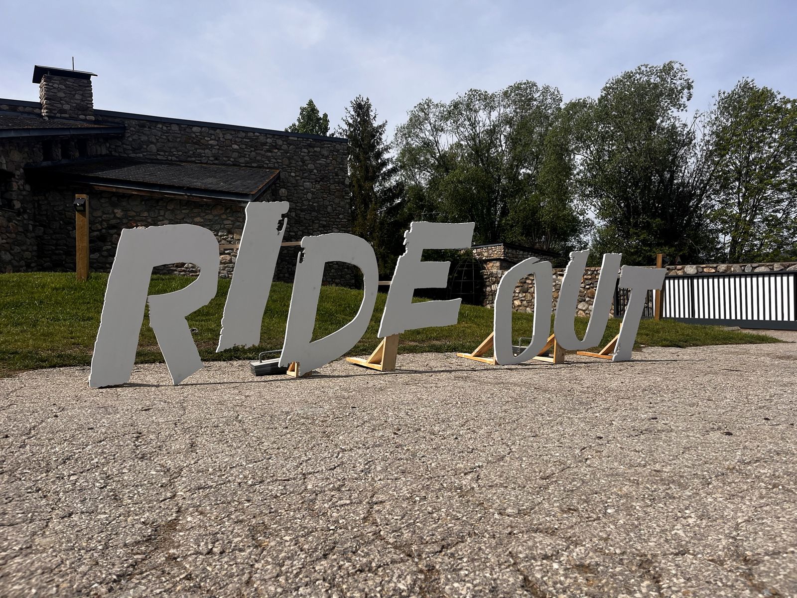 Giant white letters spelling RIDE OUT, outdoors in the Pyrenees